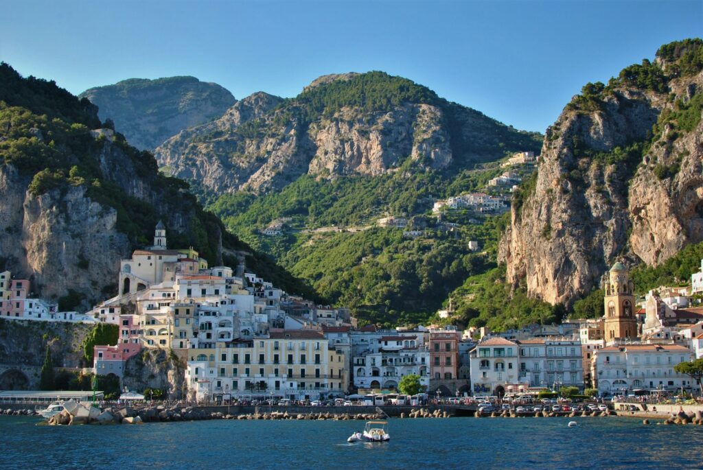 Coastal village framed by steep rocky mountains along the Amalfi Coast.